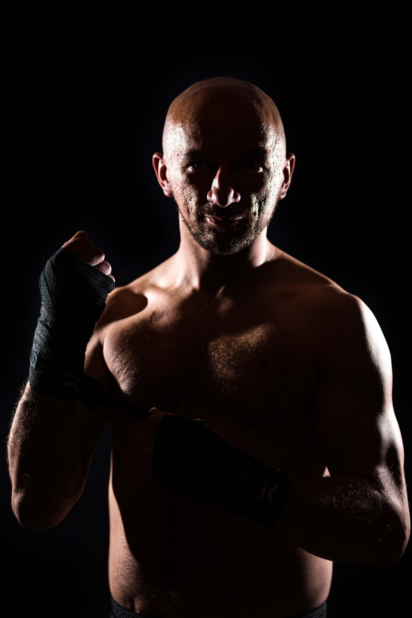 Character-driven personal branding portrait, low-key studio lighting