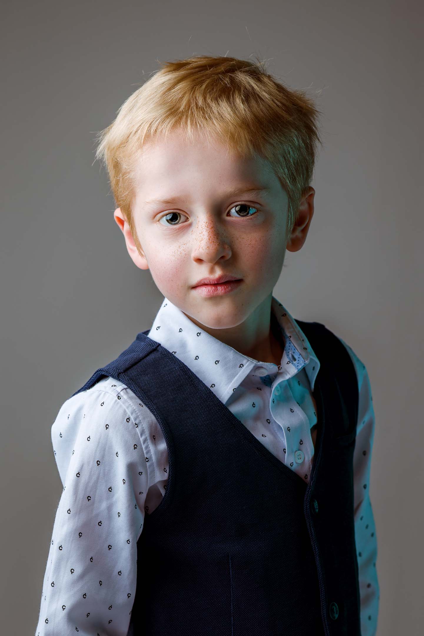 Studio family portrait of a young boy in a waistcoat