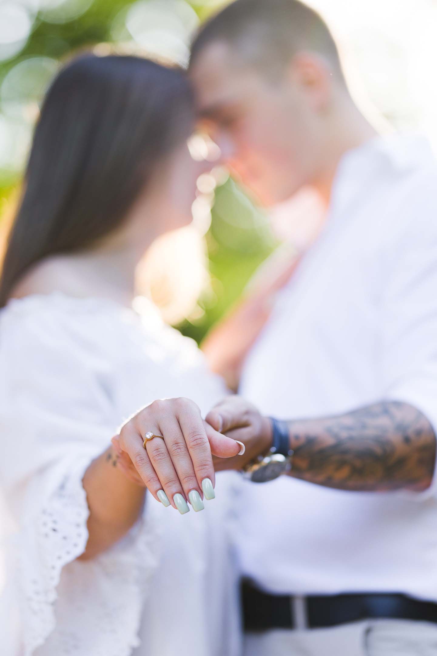 Engagement photography on location, couple holding hands showing engagement ring